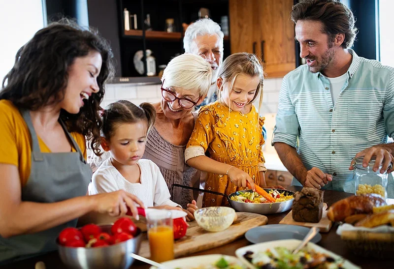 A family cooking dinner together - Income Insurance