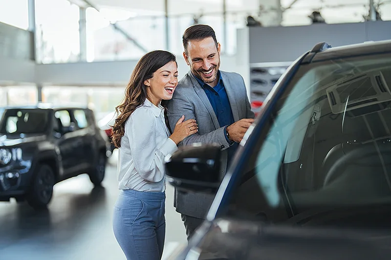 A happy couple buying a car