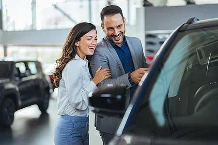 A happy couple buying a car - listing