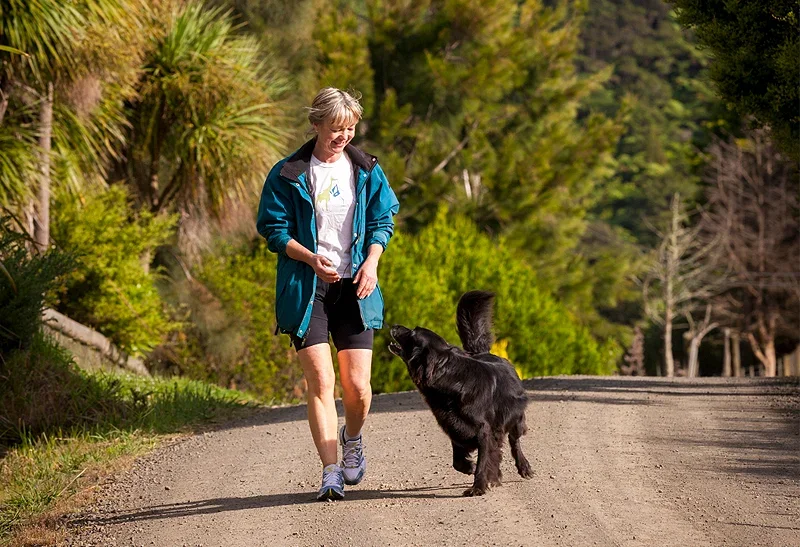 A woman walking her dog - Recovery Insurance