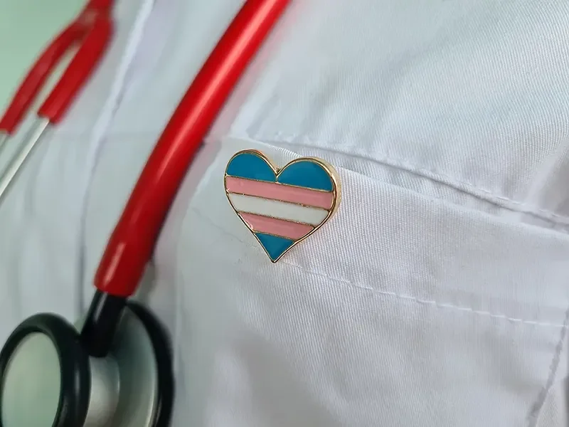 Doctor wearing trans heart pin
