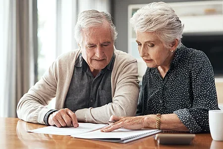 Elderly couple writing a will - listing