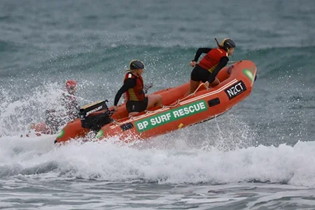 Emma Blackwell on a inflatable rescue boat in a race - listing