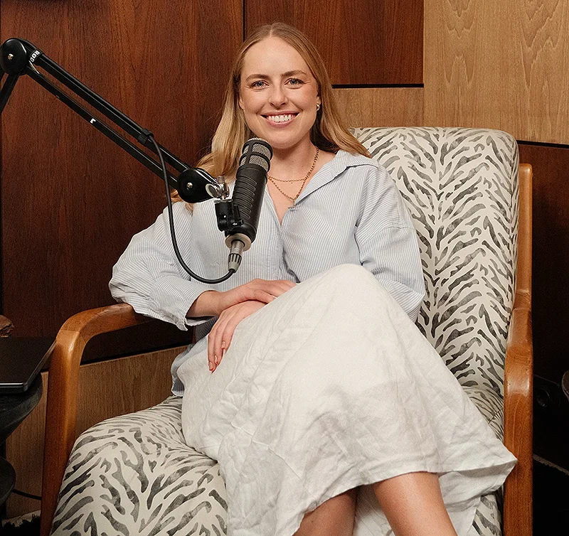 Sarah Kelsey podcasting with a microphone