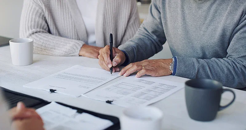 elderly couple signing a will