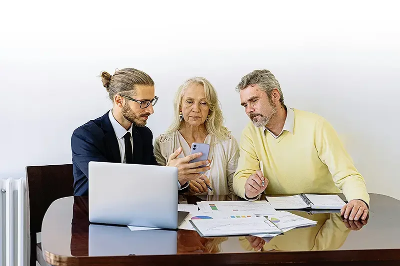 eldery couple having a meeting with someone over their policy